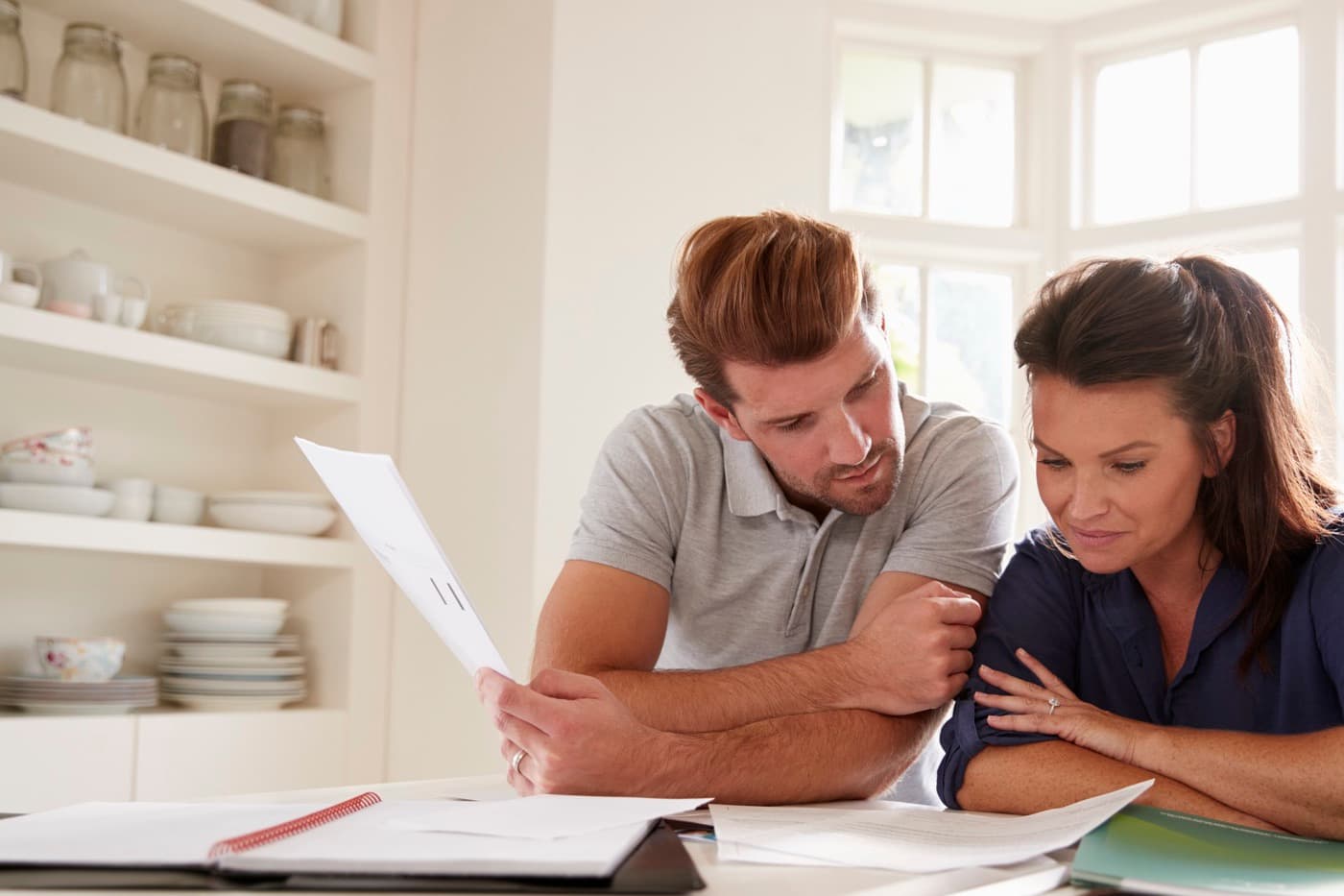 Couple reviewing documents together at home.
