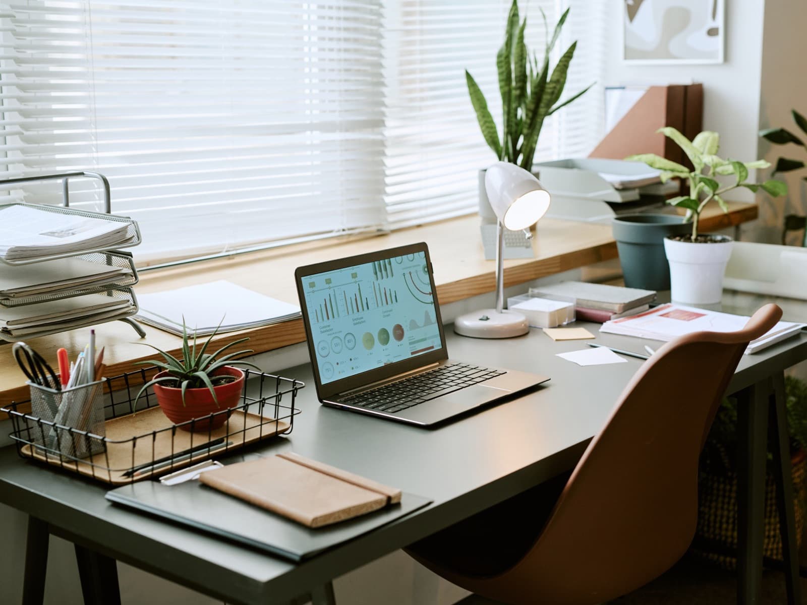 Home office desk with laptop chart.