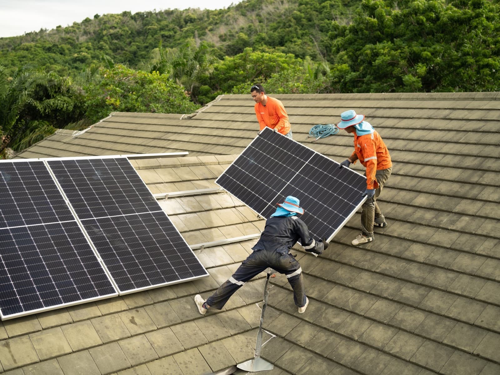 Men technicians mounting photovoltaic solar moduls.